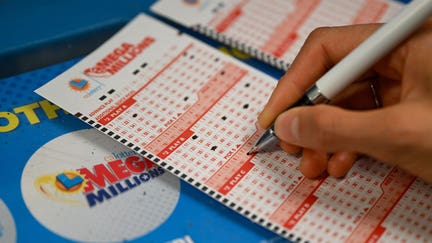 CALIFORNIA, USA - AUGUST 8: A person plays lottery at a 7-eleven store as Mega Millions jackpot reaches $ 1 billion 580 million, in Redwood City, California, United States on August 8, 2023.