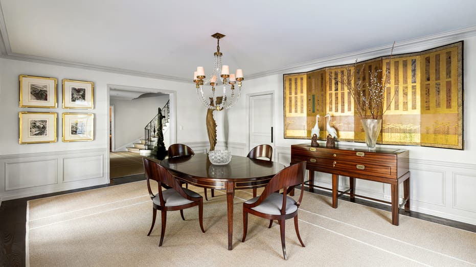 Picture of a dining room in Judy Garland's old home in Bel-Air with a brown dining table 