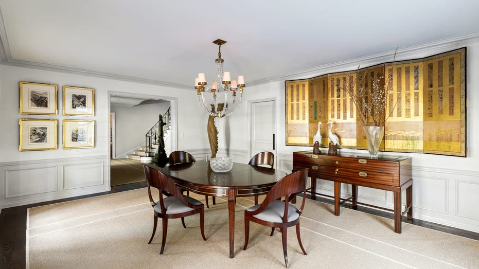 Picture of a dining room in Judy Garland's old home in Bel-Air with a brown dining table 