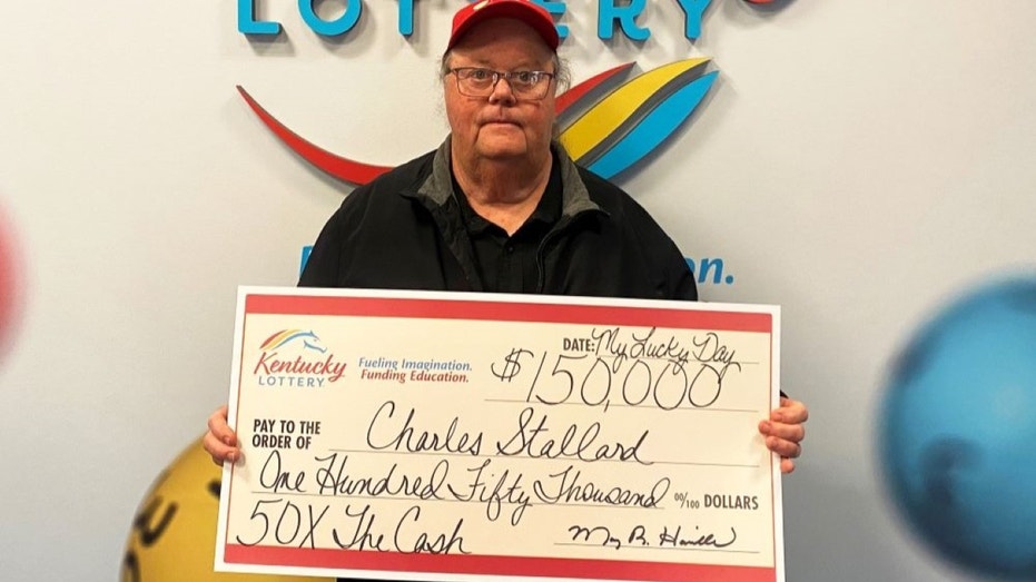 Charles Stallard holding check
