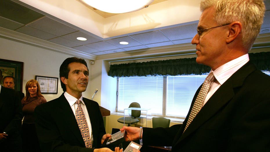 Men in suits swapping stamps