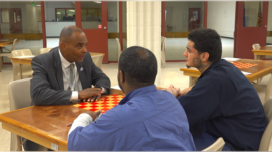 Three men talking at a table