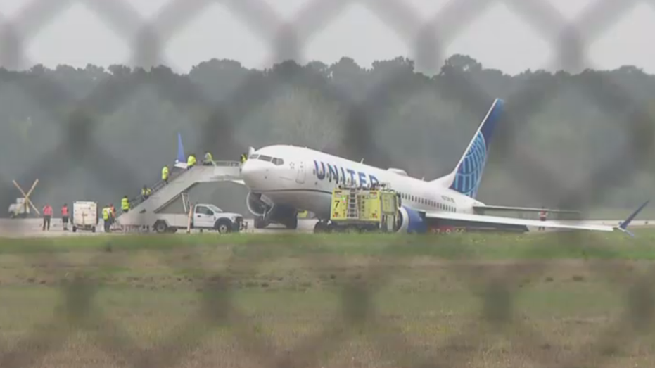 United Airlines plane skids off Houston airport runway