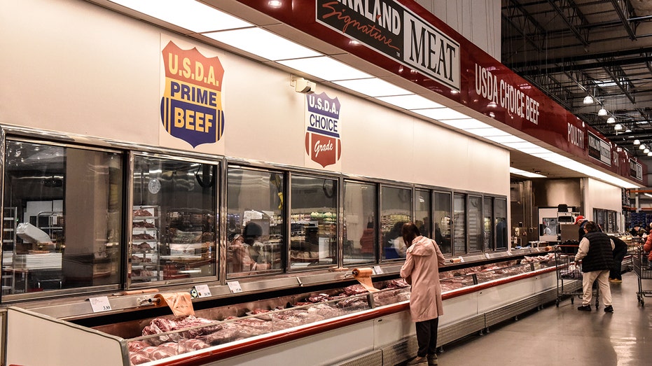 A photo of customers shopping in the Costco meat department