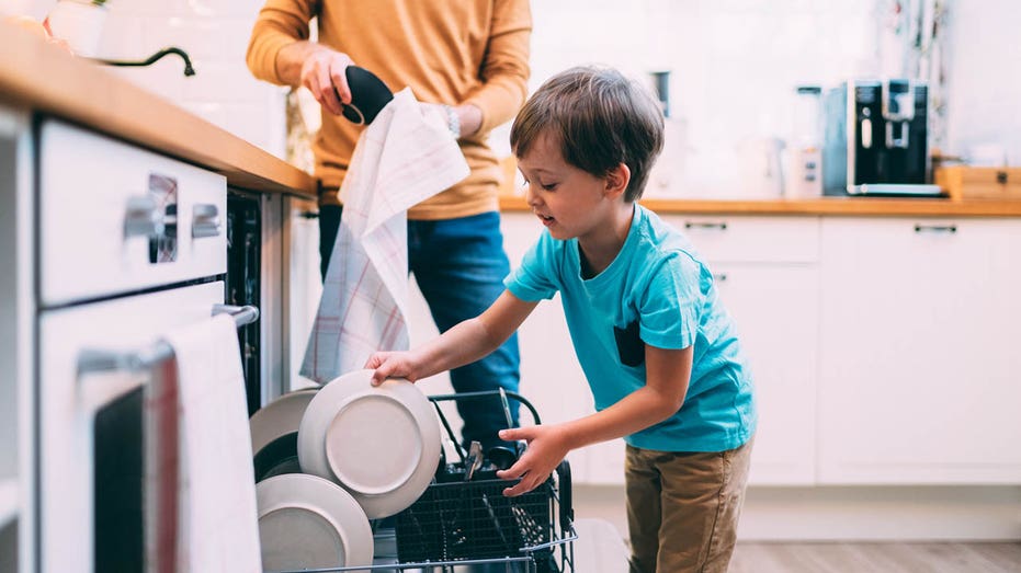 little boy doing chores