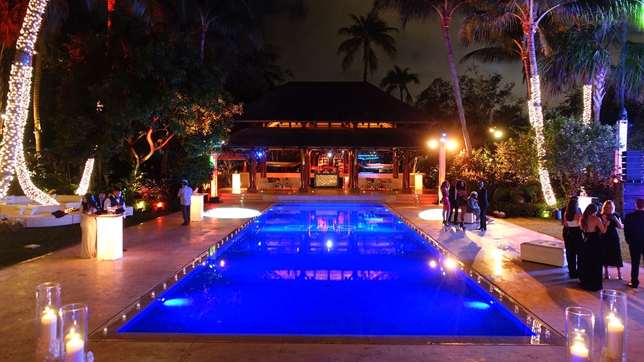 A pool at nighttime in Sean Diddy Combs' house