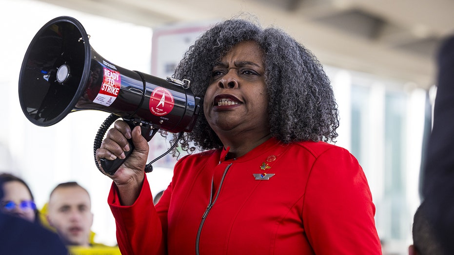 A Southwest Airlines flight attendant pickets outside O'Hare International Airport