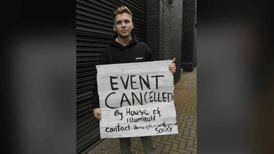 Man holding EVENT CANCELLED sign