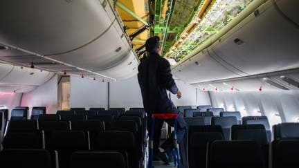 A worker during the refitting of the economy class cabin of a Boeing Co. 777-300ER aircraft, operated by Air France-KLM, at the Air France Industries hanger at Orly Airport in Paris, France, on Tuesday, Sept. 27, 2022. Air France will progressively equip twelve of their 777-300ER aircraft with new business class seats for international flights and complete all the business cabins in the airlines fleet in 2023. 