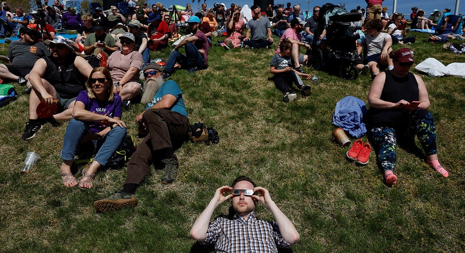 People gather at Saluki Stadium, ahead of a total solar eclipse in Carbondale, Illinois