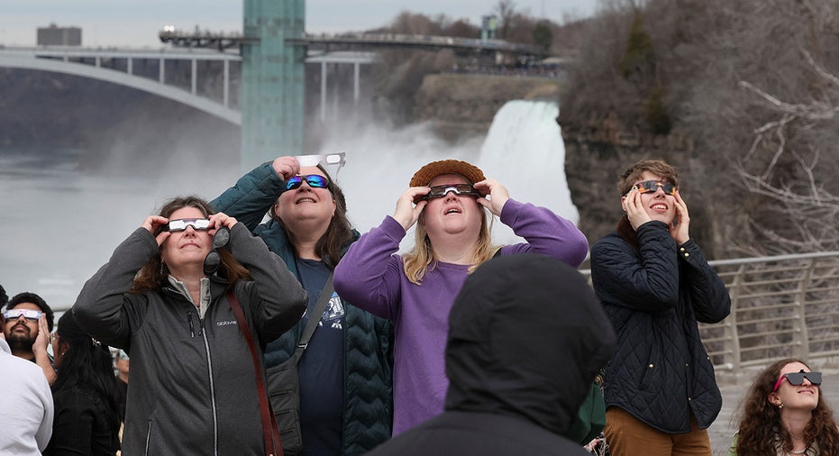 People look to the sky ahead of a total solar eclipse at Niagara Falls