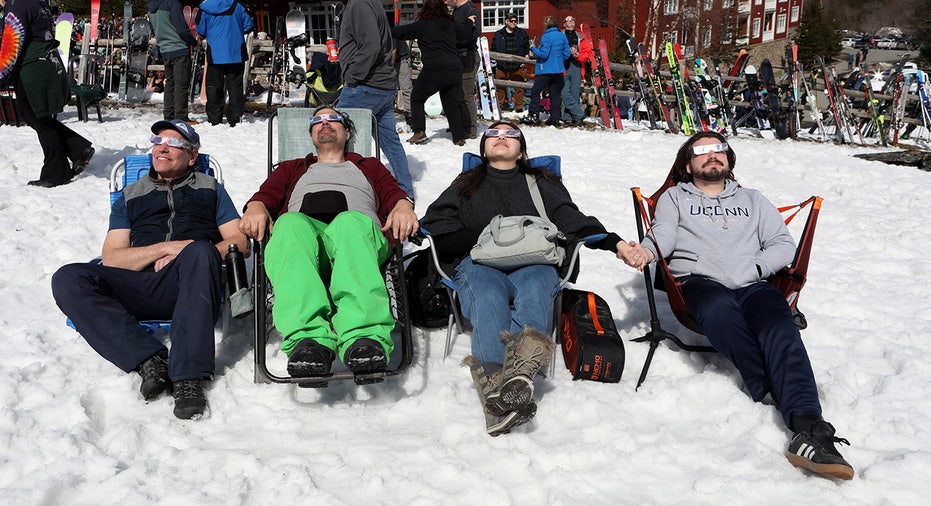 People assemble to view the total solar eclipse at Sugarbush ski resort in Warren, Vermont