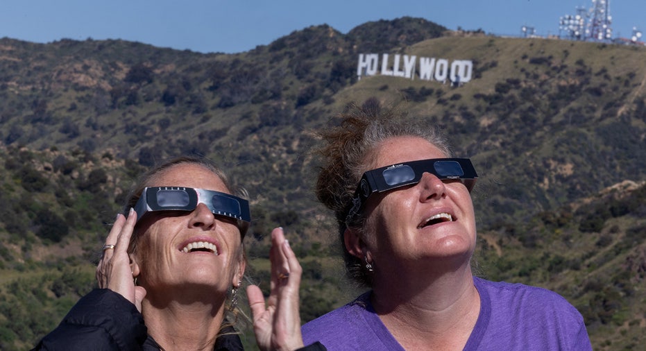 Australian tourists Sharon Bucklee and Nikki Conway join the crowd of solar eclipse watchers at Griffith Observatory