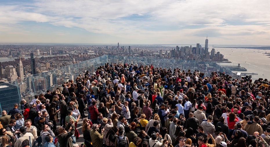 People watch a partial solar eclipse on the observation deck of Edge at Hudson Yards in New York City