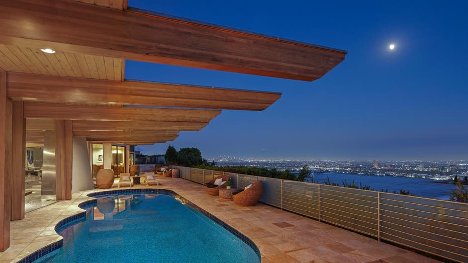 night view of pool and deck