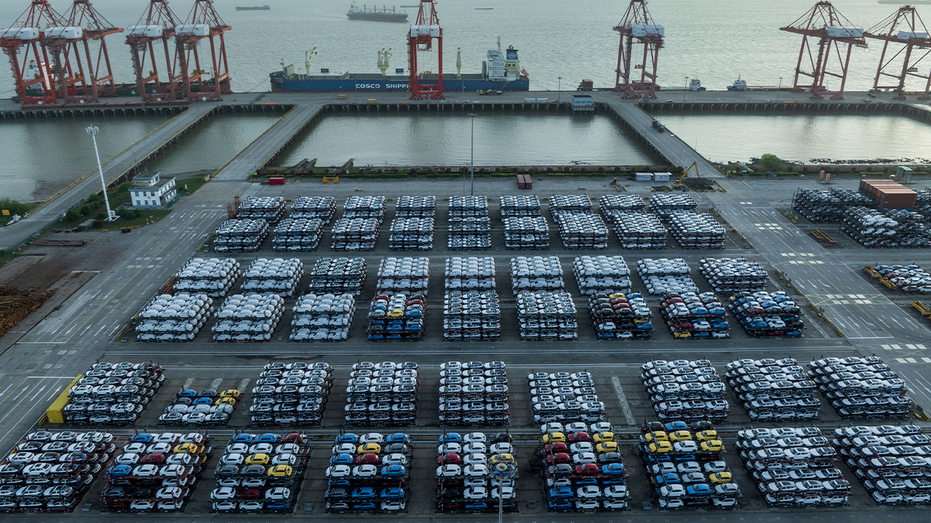 New energy vehicles are being exported through a special frame transport at the International Container Terminal in the Taicang Port area of Suzhou Port, in Suzhou, China, on April 19, 2024.