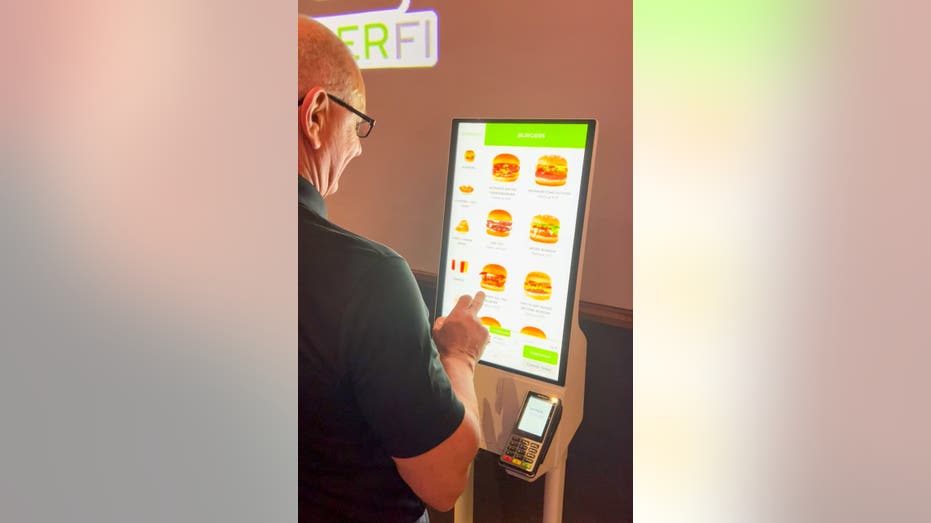 Robert Irvine using digital menu kiosk