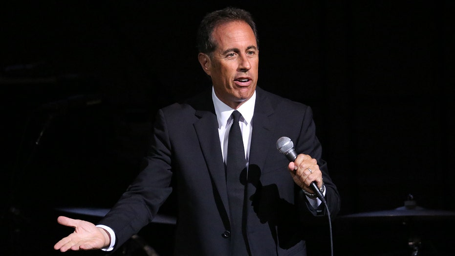 Jerry Seinfeld performs on stage