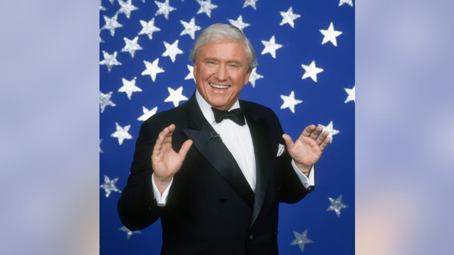 Merv Griffin with hands waving