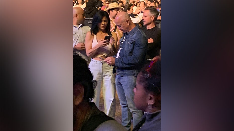 ONE TIME USAGE ONLY Jeff Bezos, Lauren Sanchez, and Corey Gamble enjoy Lana Del Rey during the first weekend of the Coachella Music Festival