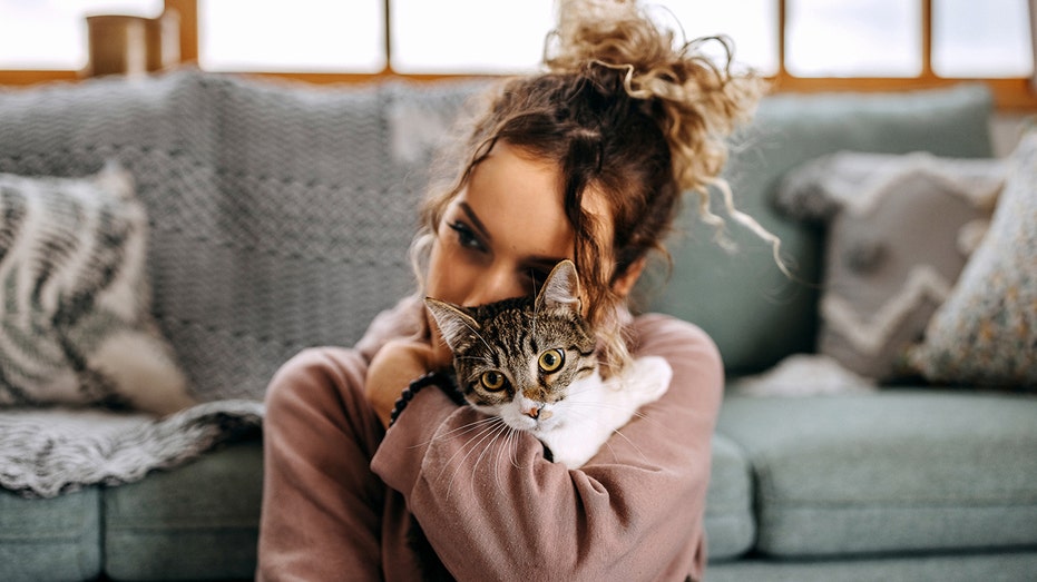 Woman cuddling kitten