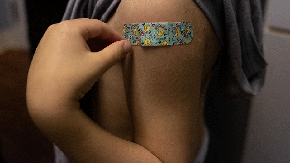 A band-aid on child's arm after receiving vaccine