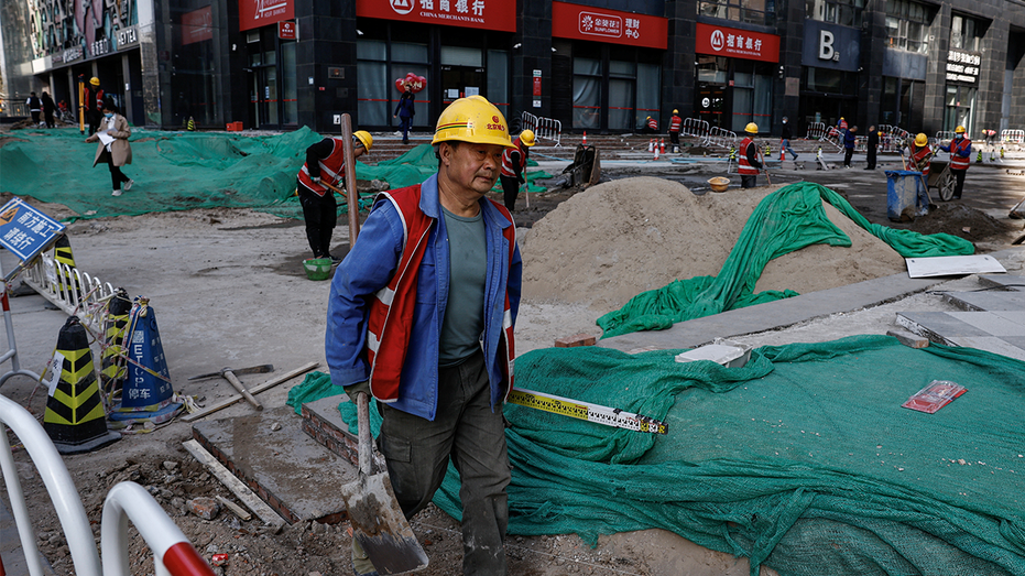 A worker labours astatine a building tract successful Beijing.