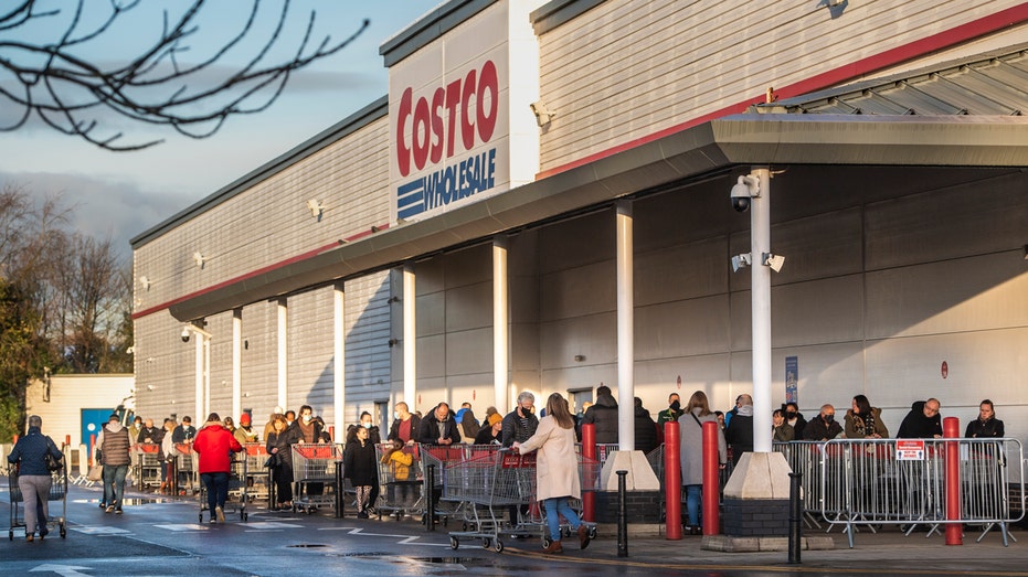 Costco exterior shows shoppers in line
