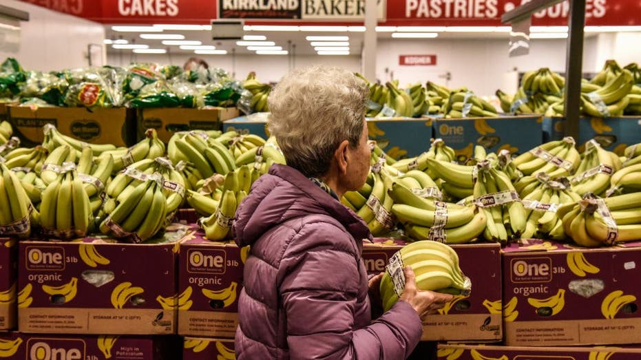 woman shopping for bananas