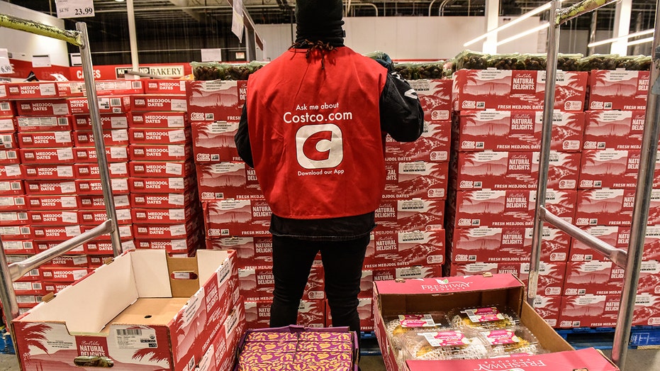 A worker arranges produce at a Costco store in New Jersey