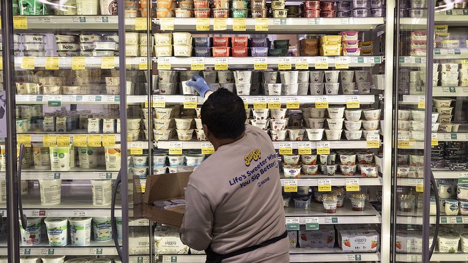 A worker stocks shelves in Washington, DC