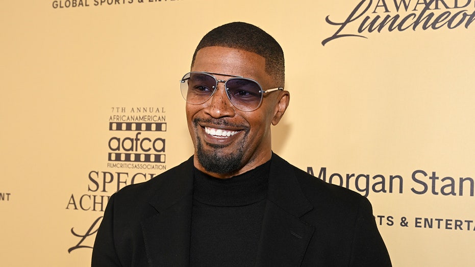 Actor Jamie Foxx sports sunglasses and a black blazer