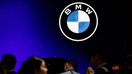 Visitors walk past a BMW logo at the Beijing International Automotive Exhibition, or Auto China 2024, in Beijing, China, April 25, 2024.