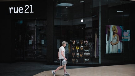 A shopper walks past a closed Rue 21 store in the re-opened Anderson Mall in Anderson, South Carolina, on Friday, April 24, 2020. After rescinding an April 3 executive order, Governor Henry McMaster set the stage for clothing, department, furniture, jewelry and sporting goods stores to reopen their doors to customers. Photographer: Dustin Chambers/Bloomberg via Getty Images