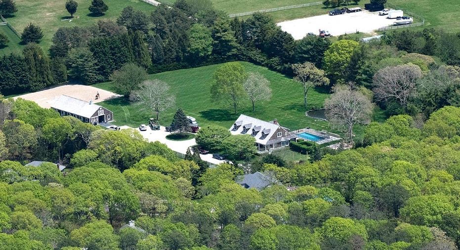 Aerial view of a stately home on a lush green property