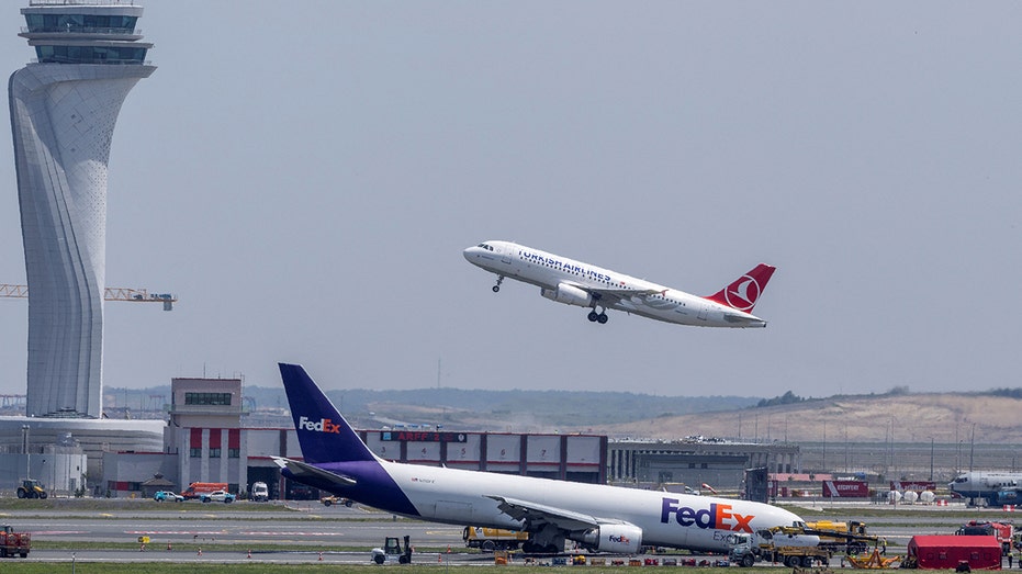 Plane by air traffic control tower