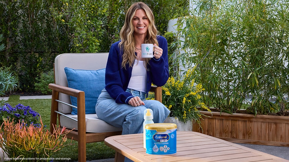 erin andrews sits with a cup of coffee in front of enfamil