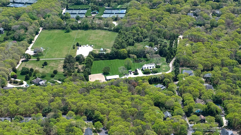 Aerial view of a stately home on a lush green property