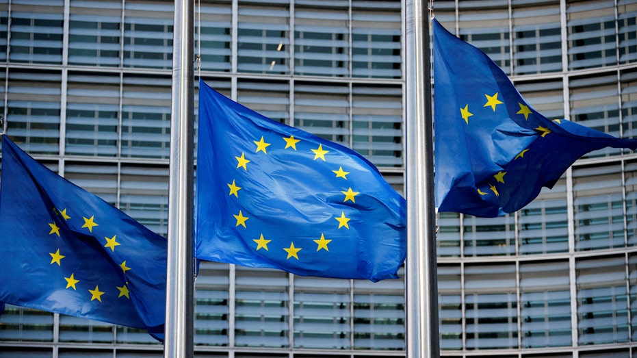 European Union flags fly outside the European Commission headquarters in Brussels, Belgium.