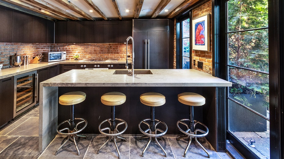 Kitchen with tan barstools