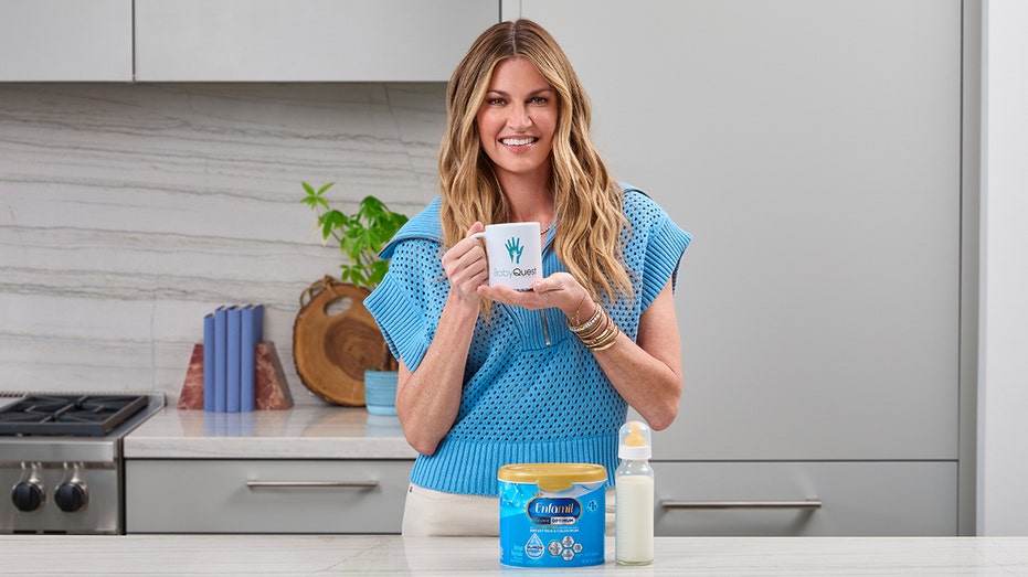 erin andrews poses with enfamil formula and a mug