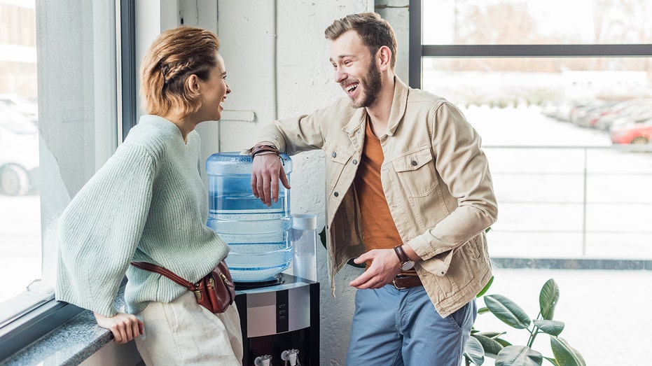 coworkers talking around the water cooler -- busy bragging trend