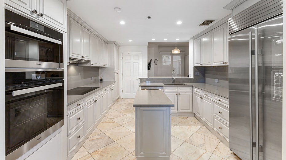 The gray and white kitchen features plenty of counterspace and great appliances.