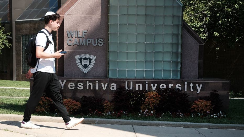 student walks on Yeshiva campus