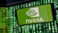 In this photo illustration, the Nvidia logo is seen displayed on a smartphone screen against a computer screen displaying a matrix image, as stock value of the company has risen dramatically due to its sales of chps needed for AI development. - Fox News