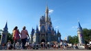 ORLANDO, FL - MAY 31: People walk in front of Cinderella&apos;s Castle at the Magic Kingdom Park at Walt Disney World on May 31, 2024, in Orlando, Florida. (Photo by Gary Hershorn/Getty Images)
