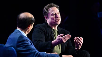 Tesla CEO Elon Musk gestures as he speaks with Michael Milken at the 27th annual Milken Institute Global Conference at the Beverly Hilton in Los Angeles on May 6, 2024.