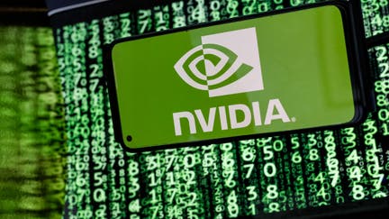 UNITED KINGDOM - 2024/06/20: In this photo illustration, the Nvidia logo is seen displayed on a smartphone screen against a computer screen displaying a matrix image, as stock value of the company has risen dramatically due to its sales of chps needed for AI development. (Photo Illustration by Dominika Zarzycka/SOPA Images/LightRocket via Getty Images)