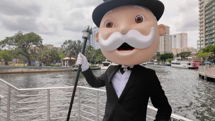 The "Monopoly Man" poses for a photograph along the New River in Fort Lauderdale, Florida, which has been selected as the newest city edition for the popular board game.