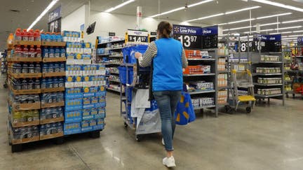  A worker walks through the aisles in a Walmart Supercenter on February 20, 2024, in Hallandale Beach, Florida. 